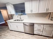 Bright kitchen features white cabinets, stainless steel appliances, and a modern quartz countertop at 7903 N 61St Ave, Glendale, AZ 85301