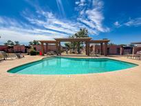 Community pool with lounge seating on a sunny day at 7903 N 61St Ave, Glendale, AZ 85301