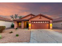 Charming single-story home with a two-car garage, neutral desert landscaping and a warm, inviting exterior at 8433 E Natal Cir, Mesa, AZ 85209