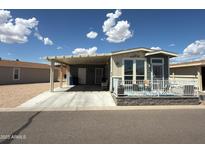 Charming home featuring a carport and front patio area, perfect for relaxing and enjoying the outdoors at 8865 E Baseline Rd # 614, Mesa, AZ 85209