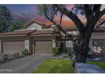 Charming two-story home featuring a brown tile roof, stucco walls, and two-car garage at 9705 E Mountain View Rd # 1096, Scottsdale, AZ 85258