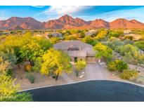 Beautiful single-Gathering home with desert landscaping and a majestic mountain backdrop at sunset at 10694 E Redfield Rd, Scottsdale, AZ 85255