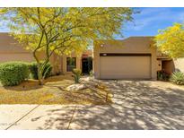 Charming home featuring a well-maintained front yard with desert landscaping and mature desert trees at 11775 E Becker Ln, Scottsdale, AZ 85259