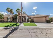 Beautiful home featuring a well-manicured lawn, desert landscaping, and an attached two-car garage at 1207 E Clearview Dr, Casa Grande, AZ 85122