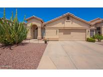 Charming single-story home with a two-car garage and desert landscaping at 1432 W Hopi Dr, Chandler, AZ 85224