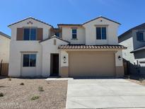 Inviting two-story home featuring a neutral stucco finish, tile roof, and a two-car garage at 18383 W Monte Lindo Ln, Surprise, AZ 85387