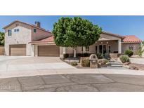 Charming home featuring a well-maintained front yard, attached garage, and stylish desert landscaping at 2254 E Becker Ln, Phoenix, AZ 85028