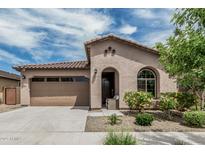 Charming single-story home featuring stucco siding, a tile roof, and a well-manicured front yard with shrubs at 23068 E Stacey Rd, Queen Creek, AZ 85142