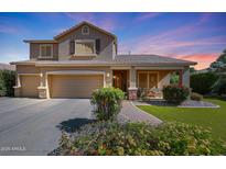 Charming two-story home with a three-car garage, covered porch, and mature landscaping under a colorful sky at 2886 E Hazeltine Way, Chandler, AZ 85249
