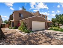 Charming home featuring a two-car garage, desert landscaping, and a welcoming facade at 2941 E Nisbet Ct, Phoenix, AZ 85032