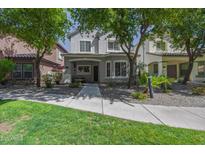 Charming two-story home with well-maintained landscaping and inviting curb appeal at 3065 E Tamarisk St, Gilbert, AZ 85296