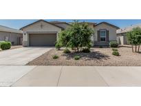 Charming single-story home with a low-maintenance front yard and a two-car garage at 37645 W Santa Clara Ave, Maricopa, AZ 85138