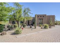 Attractive desert-style home with native landscaping, mature trees, and a brick-paved driveway at 4772 E Agave Ln, Cave Creek, AZ 85331