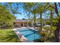 Beautiful backyard pool and patio area surrounded by lush landscaping, creating a relaxing outdoor retreat at 6648 E Horseshoe Rd, Paradise Valley, AZ 85253