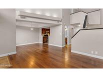 Bright living space with hardwood floors, neutral walls, and an open layout that flows into the kitchen and staircase at 7835 E Glenrosa Ave # 13, Scottsdale, AZ 85251