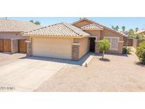 Charming single-story home featuring a well-maintained yard, two-car garage, and neutral color palette at 8657 E Capri Ave, Mesa, AZ 85208