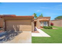 Charming home featuring a tile roof, well-maintained lawn, and inviting curb appeal on a sunny day at 9512 W Mcrae Way, Peoria, AZ 85382