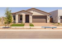 Charming single-story home with a stucco facade, a brick driveway, and manicured landscaping at 10224 E Utah Ave, Mesa, AZ 85212