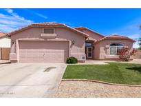 Charming single-story home featuring a two-car garage, desert landscaping, and a well-maintained lawn at 11266 E Dartmouth Cir, Mesa, AZ 85207