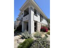 Multi-story home boasts lush landscaping with mature trees, plants, and rocky areas at 15221 N Clubgate Dr # 2065, Scottsdale, AZ 85254