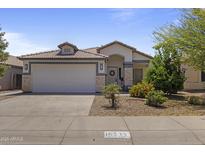 Charming single-story home featuring a tile roof, a two-car garage, and well-maintained desert landscaping at 16235 W Cottonwood St, Surprise, AZ 85374