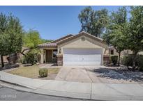 Charming single-story home with a two-car garage and well-maintained front yard at 17953 N Lettere Cir, Maricopa, AZ 85138