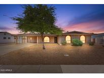 Charming single-story home featuring arched windows, desert landscaping, and a covered carport at 1902 E 8Th St, Mesa, AZ 85203