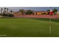 Picturesque view of the golf course with green fairway and the beautiful homes in the background at 22208 N San Ramon Dr, Sun City West, AZ 85375