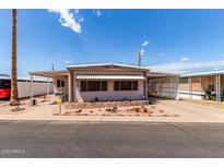 Charming single-story home with well-maintained landscaping and covered parking on a sunny day at 2700 E Allred Ave # R87, Mesa, AZ 85204