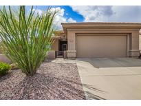 Exterior elevation of home showcasing the front yard, garage and desert landscaping at 41202 N Rolling Green Way, Anthem, AZ 85086