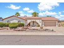 Charming single-story home featuring a tile roof and well-maintained desert landscaping in the front yard at 5126 W Las Palmaritas Dr, Glendale, AZ 85302