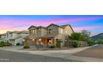 Beautiful two-story home with a three-car garage, stone accents, and professional landscaping at 5231 W Desperado Way, Phoenix, AZ 85083