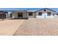 Charming single-story home with a xeriscaped front yard and covered parking at 632 N 95Th St, Mesa, AZ 85207