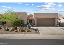 Charming single-story home featuring a low-maintenance desert landscape and a two-car garage at 6579 E Shooting Star Way, Scottsdale, AZ 85266