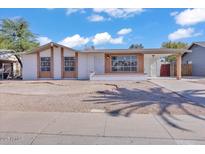 Charming single-story home featuring brick accents and a low-maintenance gravel front yard at 7614 W Cheery Lynn Rd, Phoenix, AZ 85033