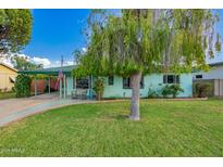 Charming single-level home featuring a well-maintained lawn, mature landscaping, and a covered carport at 811 W Ocotillo Rd, Phoenix, AZ 85013