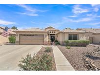 Inviting single-story home with a well-manicured front yard, neutral tones, and a convenient two-car garage at 8420 W Cherry Hills Dr, Peoria, AZ 85345