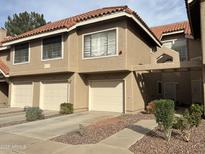Charming townhome with well-maintained landscaping and attached garages at 1633 E Lakeside Dr # 39, Gilbert, AZ 85234
