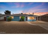 Charming single story home with manicured landscaping and inviting curb appeal at dusk at 2144 W 1St Pl, Mesa, AZ 85201