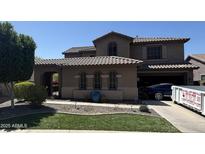 Elegant two-story home featuring a tile roof, arched windows, and well-maintained landscaping in a suburban setting at 2670 S Dragoon Dr, Chandler, AZ 85286