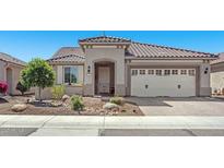 Charming home featuring desert landscaping, a tile roof, and an attached two-car garage at 26915 W Piute Ave, Buckeye, AZ 85396