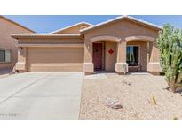 Charming single story home with a two car garage, neutral colored stucco, and xeriscaping for low maintenance at 28834 N Spur Dr, San Tan Valley, AZ 85143