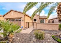 Charming single-story home featuring desert landscaping, a two-car garage, and a private gated entrance at 28837 N 127Th Ave, Peoria, AZ 85383