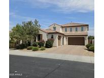 Charming two-story home featuring a tile roof and a well-manicured front yard with beautiful shrubbery at 3796 E Rakestraw Ln, Gilbert, AZ 85298