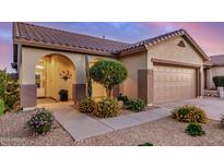 Charming single-story home with a well-manicured front yard and two-car garage, showcasing curb appeal at 40713 N Citrus Canyon Trl, Phoenix, AZ 85086