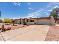 Single level home with a neutral color scheme, rock landscaping, and a two car garage at 4803 W Harmont Dr, Glendale, AZ 85302