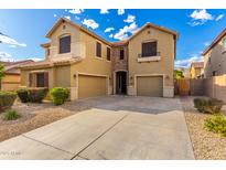 Inviting two-story home featuring a spacious three-car garage and a well-maintained gravel front yard at 7220 W Ashby Dr, Peoria, AZ 85383
