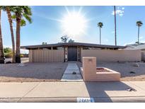 Stunning exterior showcasing mid-century modern design, desert landscaping, and a welcoming walkway to the front door at 7604 N 46Th Ave, Glendale, AZ 85301