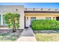Inviting home exterior featuring a well-maintained lawn, mature landscaping, and a clearly marked address at 1733 N Miller Rd, Scottsdale, AZ 85257