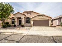 Charming single-story home with a well-manicured front yard and inviting entrance at 19824 N 14Th Pl, Phoenix, AZ 85024